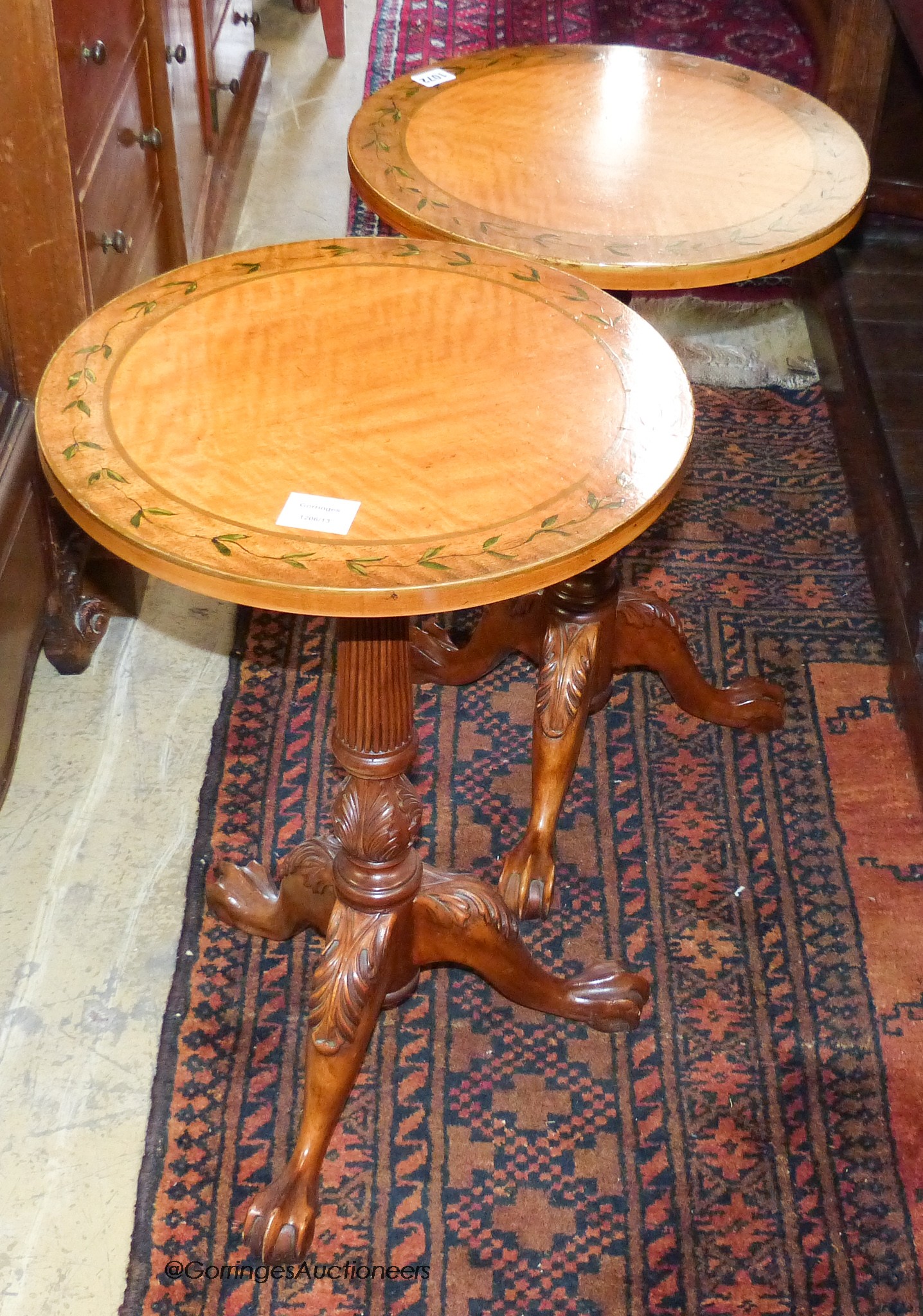 A pair of George III style painted satinwood and mahogany tripod wine tables. D-40, H-63cm.